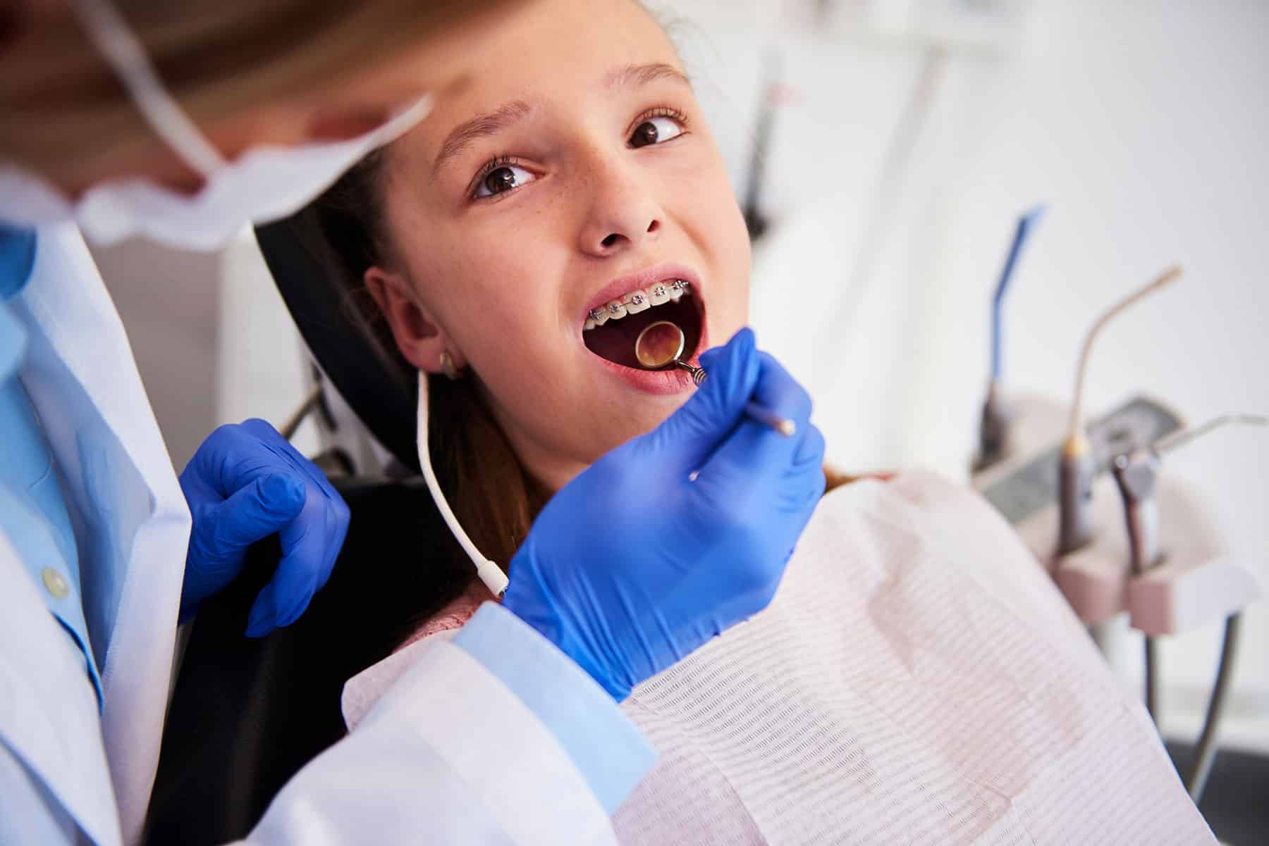 Boy with braces getting dental treatment