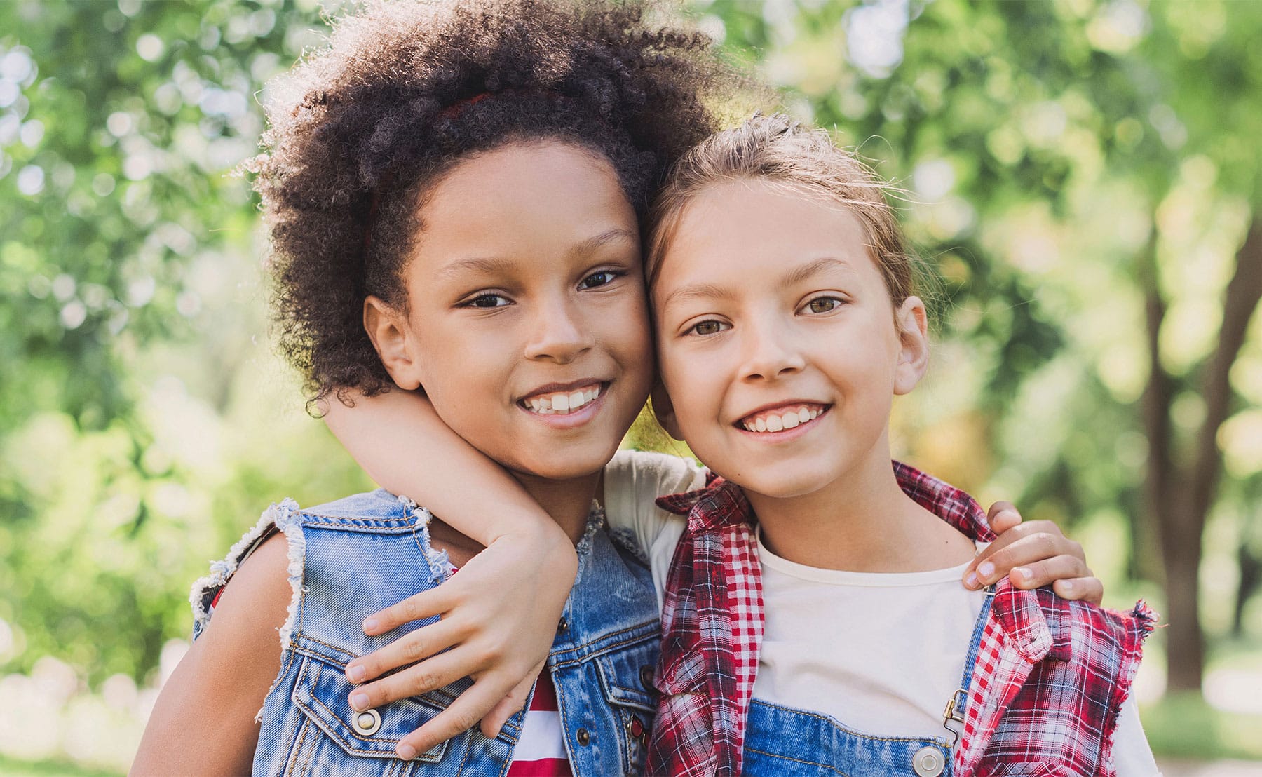 Two tween friends hugging