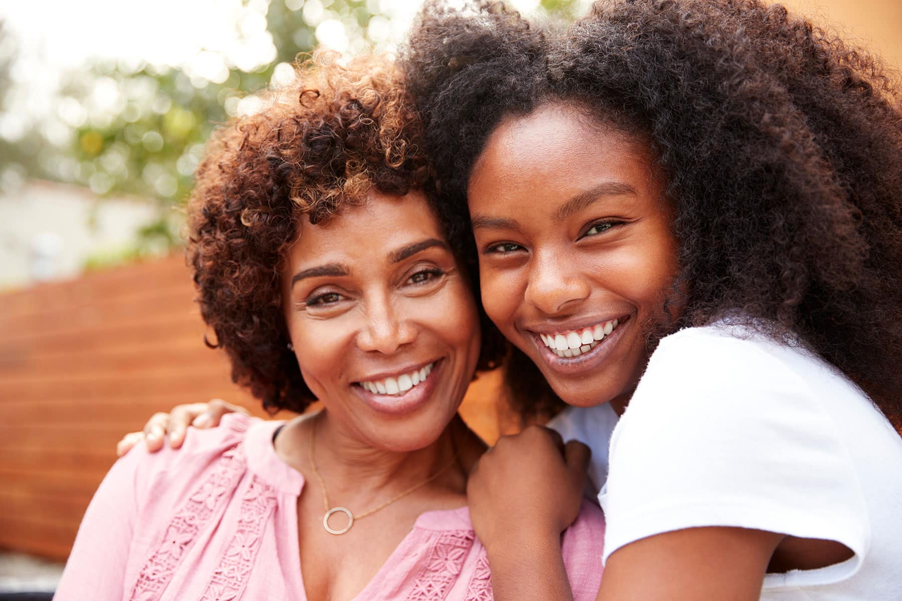 Two women smiling into camera