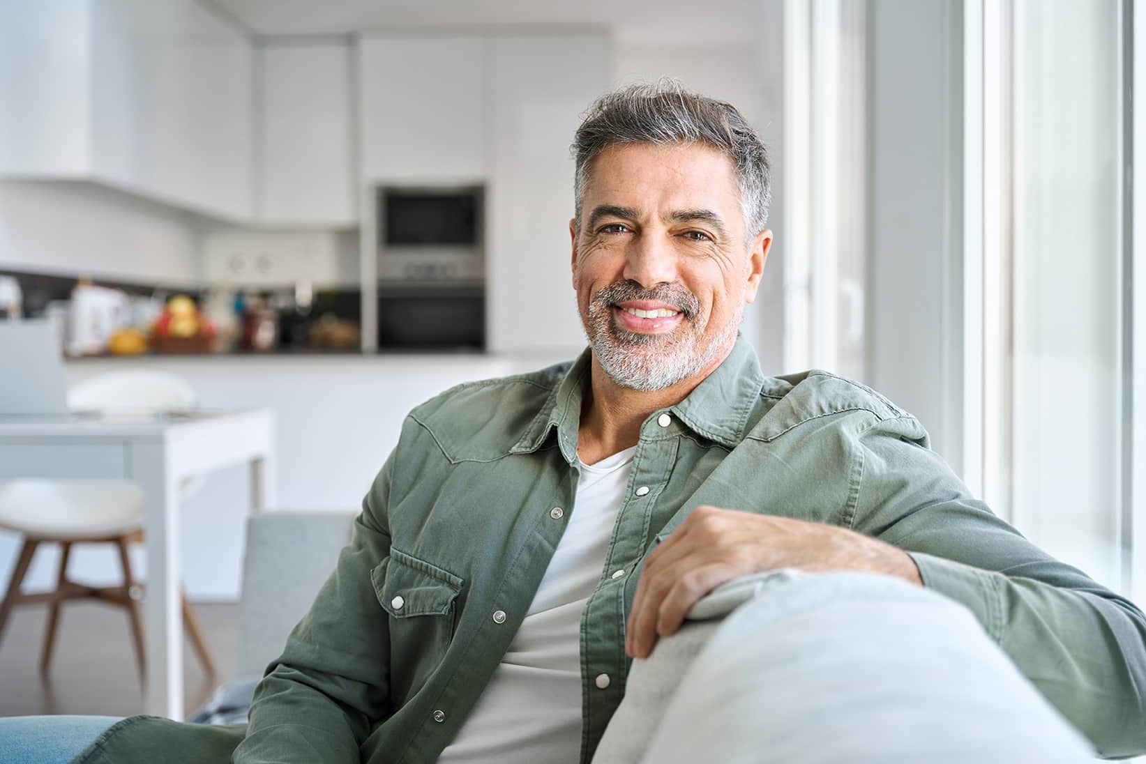 orthodontic patient sitting on a couch smiling in loveland ohio