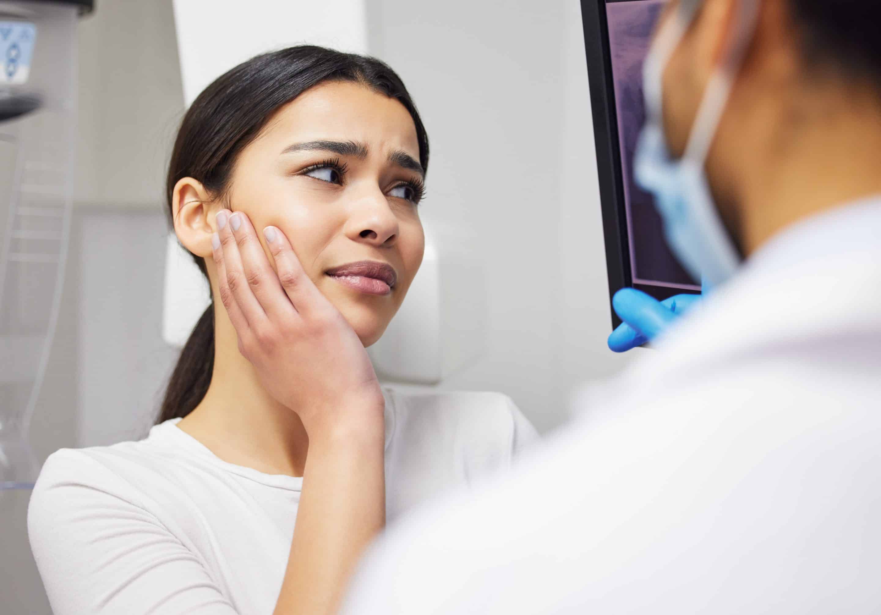 dental patient talking with dr stadiem about jaw pain during orthoganic surgery appointment at northeast orthodontic specialists